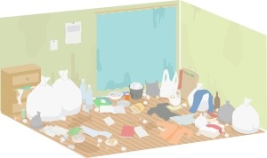 A cluttered room filled with trash bags, bottles, boxes, and papers scattered across a wooden floor in front of a blue-curtained doorway.